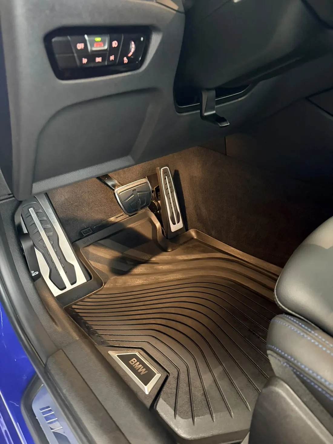 Same footwell after a full interior detail — spotless carpet